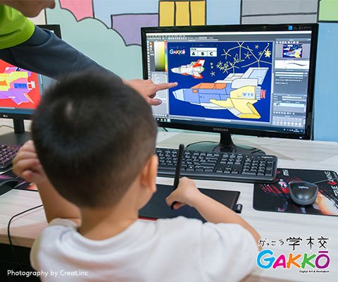 Teacher teach a kid about digital drawing and animation with personal computer