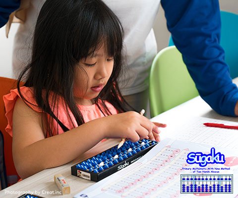 Teacher teach a kid learning how to use abacus
